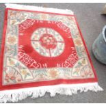 A Chinese washed wool rug with quartered floral motifs on red ground - 1.5m X 1.25m