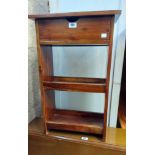 A 44cm Eastern hardwood two shelf open bookcase with drawer over