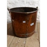 A large old copper log basket of riveted construction with brass handle