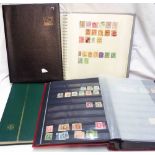 A red stock book containing sparse world stamp contents - sold with two empty stock books and a blue