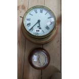 A vintage brass cased bulkhead wall timepiece with Roman numerals and eight day movement - sold with