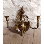An early 20th Century gilt bronze three branch candle wall sconce, with cast cherub and urn