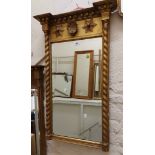 An antique Georgian style gilt framed pier mirror with beading, shell and flanking star motifs to