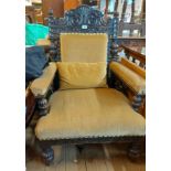 A late Victorian carved oak part show frame drawing room armchair with studded old gold velour