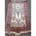 A modern handmade silk Persian pattern prayer mat with directional decoration within a double border