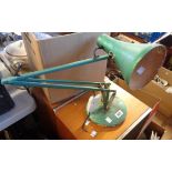 A vintage anglepoise lamp, with later metallic green painted finish, set on circular base