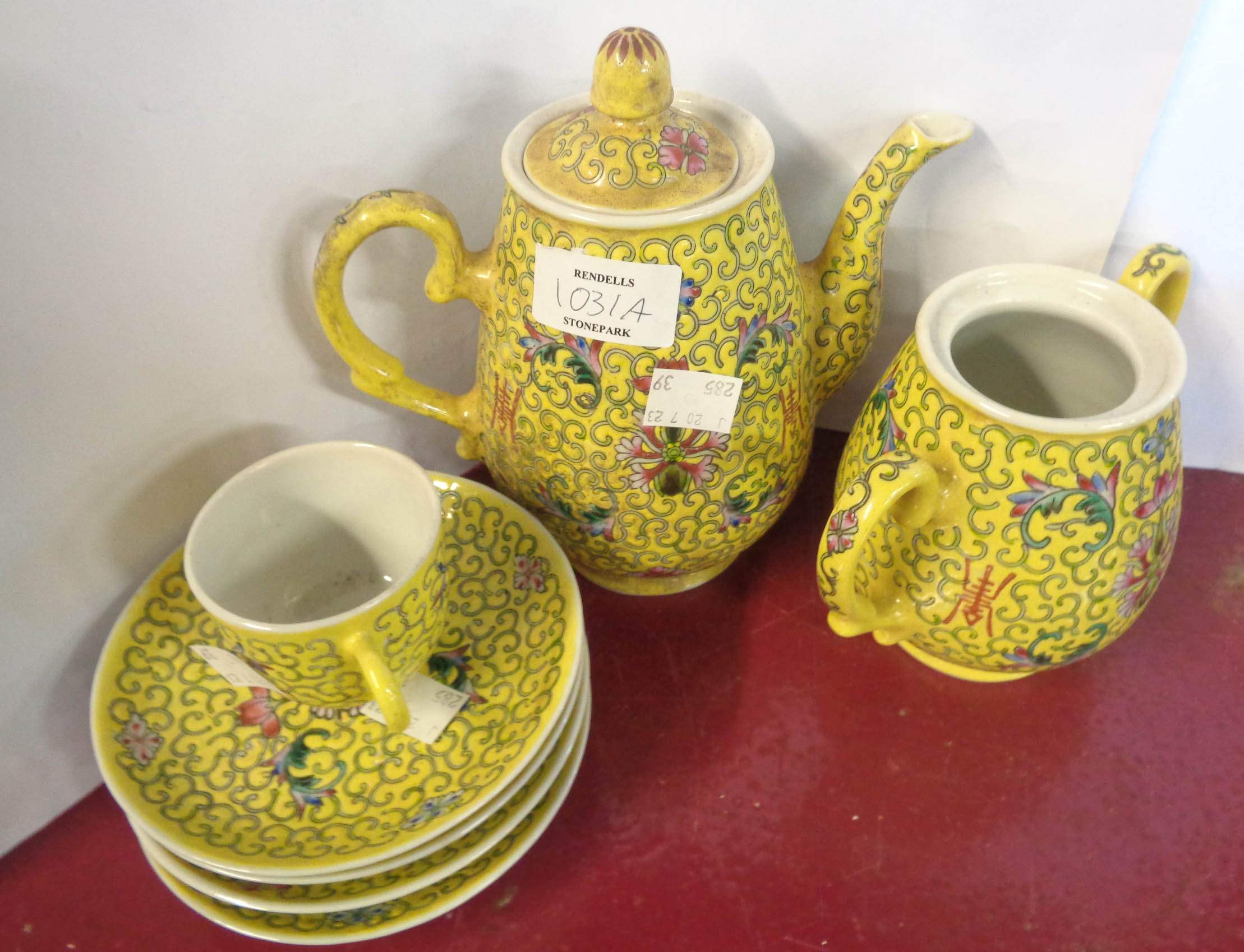 A 20th Century Chinese porcelain part tea set with enamelled decoration on a yellow ground