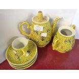 A 20th Century Chinese porcelain part tea set with enamelled decoration on a yellow ground