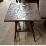 An early 20th Century carved mixed wood two tier occasional table with decorative surfaces and