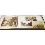 A folio album containing published stock large format photographic prints of named continental towns