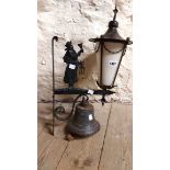 A vintage wrought and cast iron porch light with figural night watchman decoration and an opaque