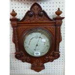 A late Victorian ornate carved walnut framed barometer with printed dial marked for Negretti &