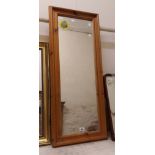 A modern pine framed narrow oblong wall mirror