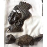 Two African carved hardwood items, comprising a female wall mask and a lizard figure