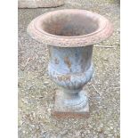 A 31cm old cast iron planter of semi reeded design