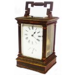 A late Victorian brass and bevelled glass cased carriage clock with reeded columns to corners, chime