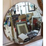 A 68cm diameter vintage frameless wall mirror with cut and bubble line decorated border