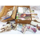 A box containing a collection of loose vintage postcards, souvenir sets, tea cards in albums, etc.