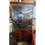 A 1.05m 19th Century mahogany corner cabinet with shelves enclosed by a pair of beaded glazed