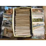 A shoebox containing a collection of mainly early 20th Century postcards including named views,
