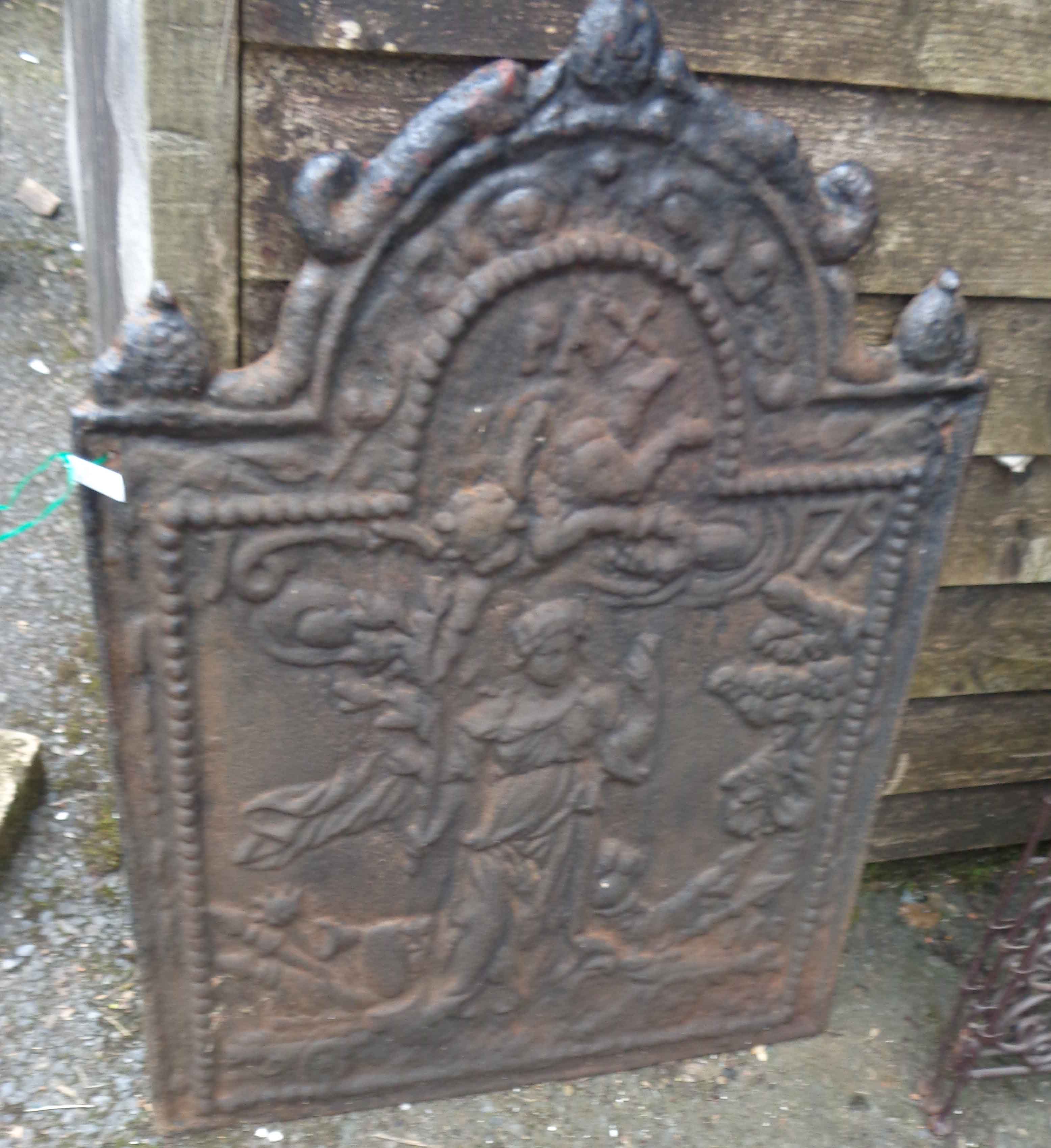 A Victorian cast iron fire back with decoration depicting a classical scene