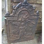 A Victorian cast iron fire back with decoration depicting a classical scene