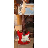 A vintage Fender Stratocaster copy, with red finish, in soft carry case