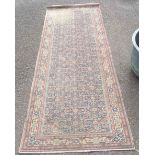 An old handmade Persian pattern wool runner with repeat geometric design within similar border -