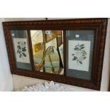 A decorative framed wall mirror with flanking floral study prints - sold with an oak framed bevelled