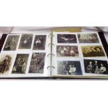 An album containing a quantity of vintage monochrome postcards, all photographic portraits, posed