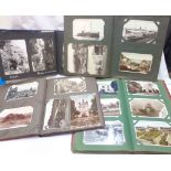 Four albums containing collections of early to mid 20th Century postcards including named views,