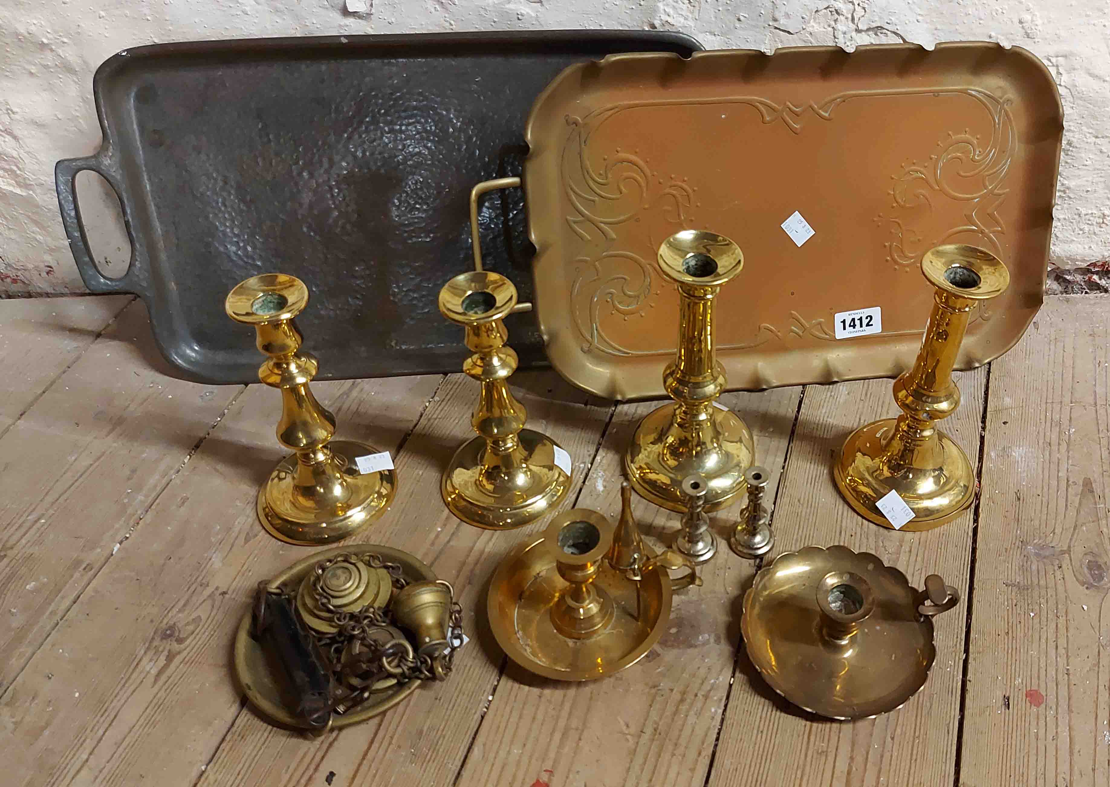 A quantity of assorted metalware including two pairs of brass candlesticks, two chambersticks,