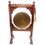 A late Victorian oak dinner gong stand with 34cm diameter gong and beater