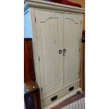 A 1.2m painted wood double wardrobe enclosed by a pair of panelled doors with long drawer under, set