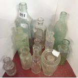 A quantity of glass bottles including T.E. Baker's Restorative Fliud, Crewkerne, etc.