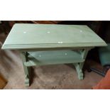 A 1.03m green painted wood two tier table with moulded top and blind frieze drawer, set on pierced