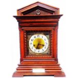 An early 20th Century mahogany cased table clock of architectural design with brass and silvered