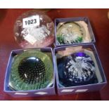 Four glass paperweights including controlled bubble and internal animal decorated examples