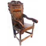A 17th Century oak wainscot chair with acanthus scroll top rail, naive inlaid border to the