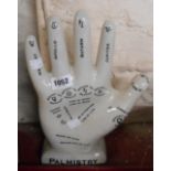 A modern ceramic Palmistry hand with black transfer printed decoration and crackle glaze finish