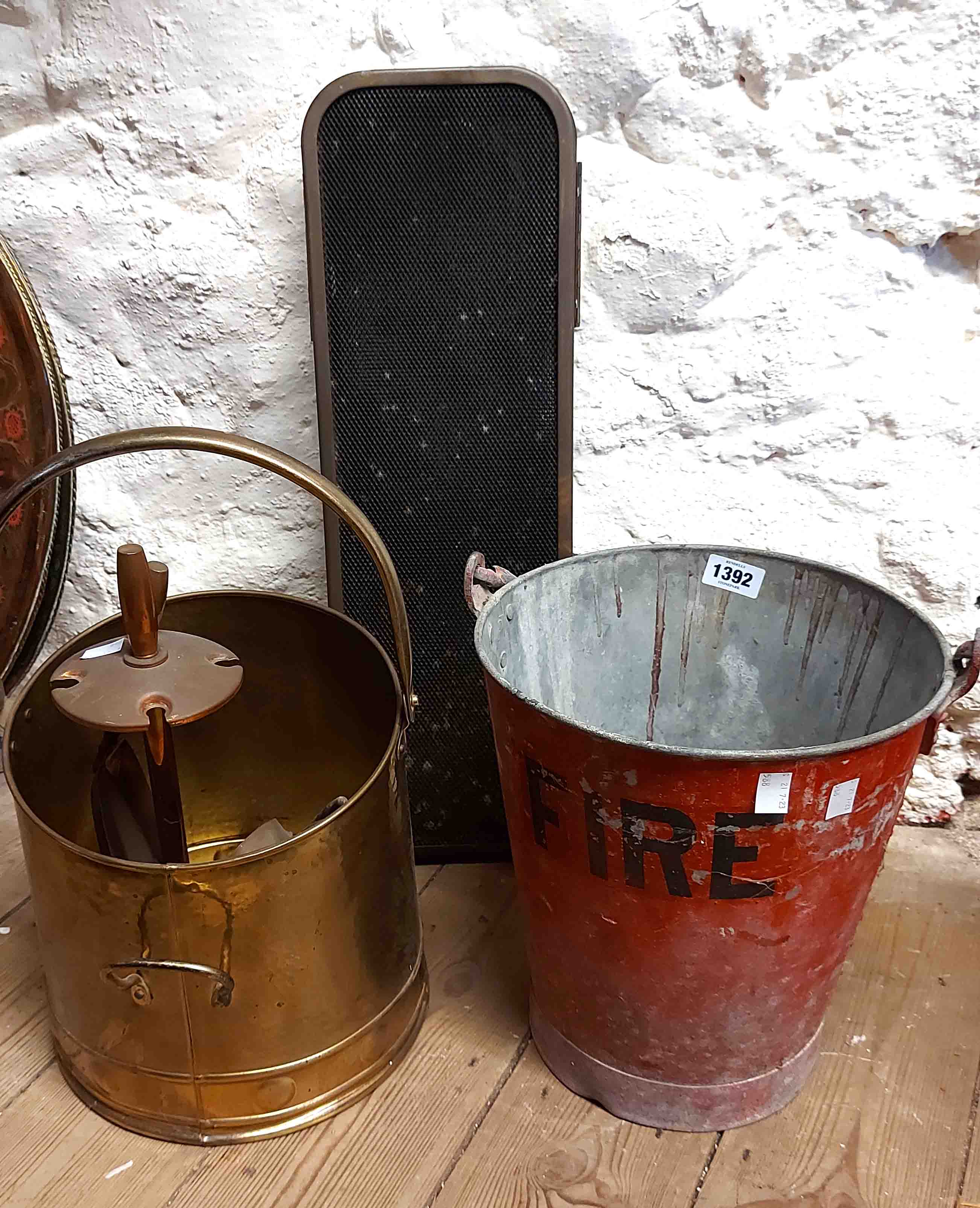 A vintage fire bucket with black lettering on a red ground with a galvanised interior - sold with