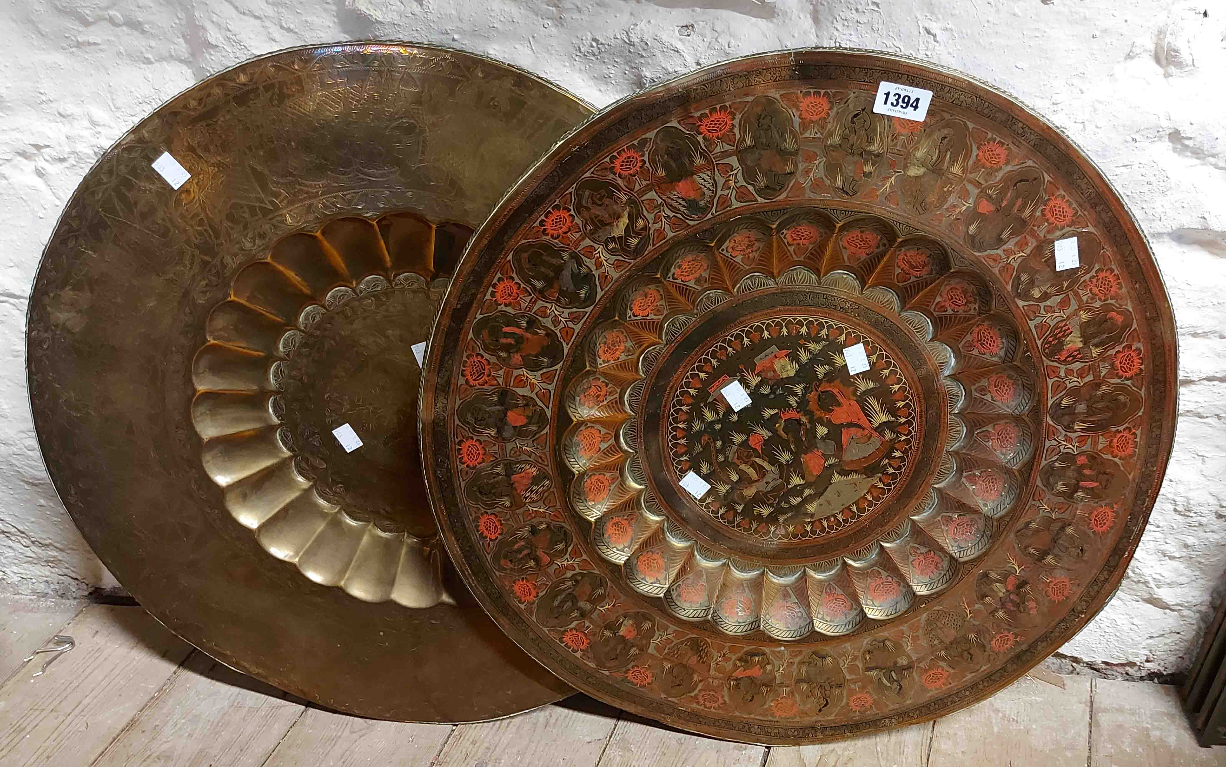 A large Eastern brass tray with chased and painted decoration - sold with another unpainted similar