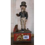 A reproduction American style painted cast iron novelty money bank depicting Uncle Sam