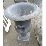 A 40cm high old cast iron planter of semi-reeded urn design