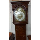 A 19th Century figured walnut longcase clock, the 30cm brass and silvered arched dial marked for