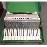 An old Italian Boselli piano accordion with faux tortoiseshell stringing and painted finish in
