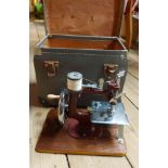 A vintage Essex miniature sewing machine with extension board, clamp and instructions, in original