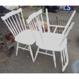 Three matching white painted wood stick back dining chairs