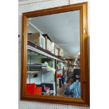 A modern pine framed bevelled oblong wall mirror - 61cm X 84cm