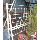 A late Victorian single bedstead with white painted cast iron frame and sprung base